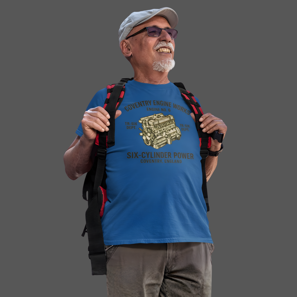 Man wearing a royal blue t-shirt with a graphic 'Coventry Engine Works' design and text, holding a backpack on a gray background