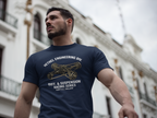 Man wearing a navy blue t-shirt with engineering graphic and text, standing in front of a building.