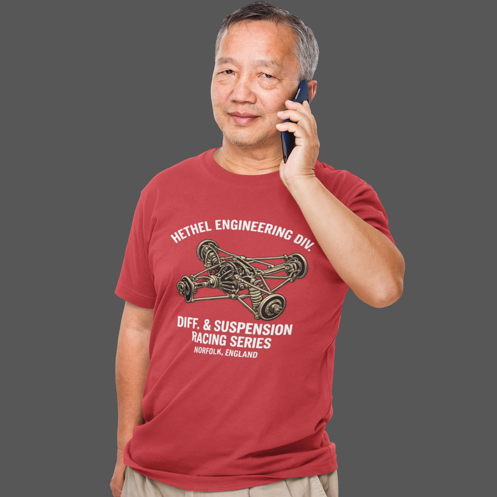 Man wearing a red t-shirt with automotive graphic and text, talking on a phone.