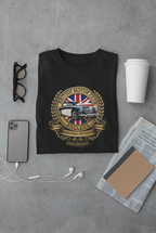Black t-shirt with a British Motor Club logo on a gray surface with a phone, glasses, and coffee cup.