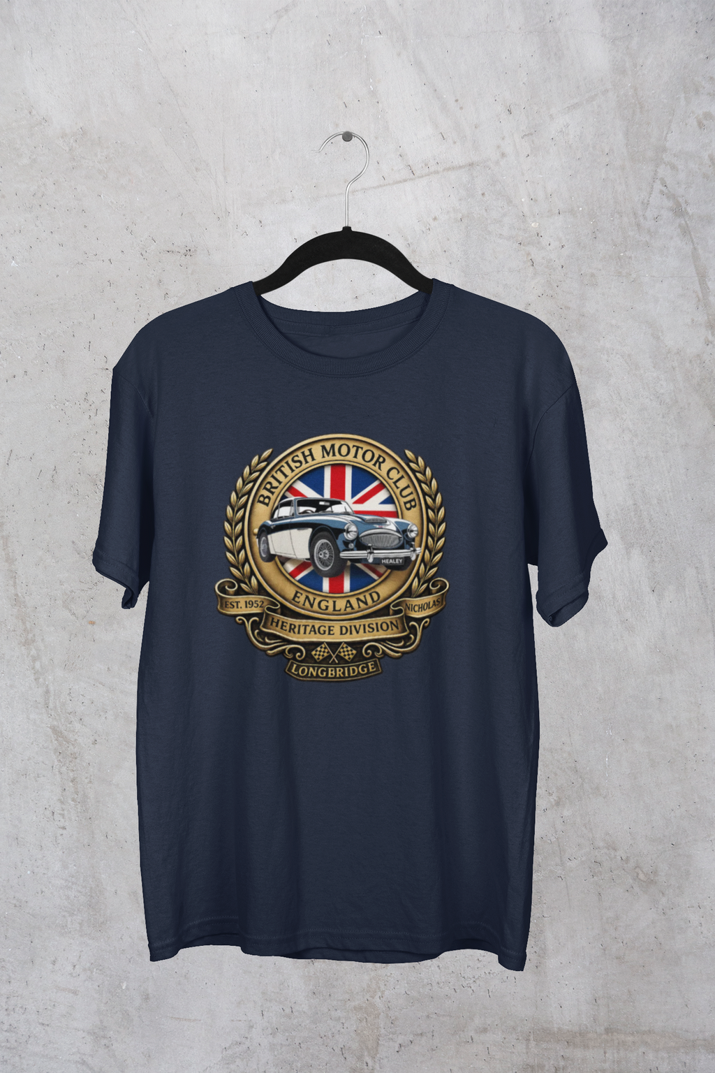 Navy blue t-shirt with a vintage car and British flag design on a hanger against a textured gray background