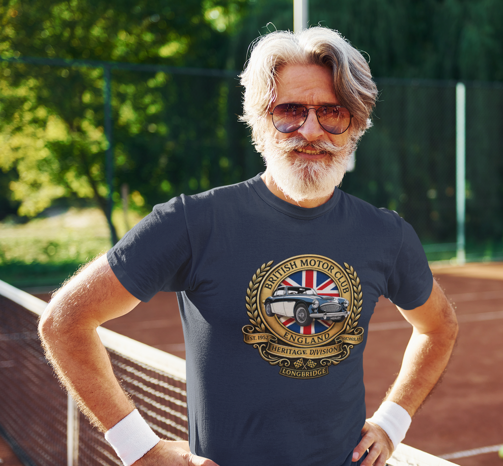 Man wearing a navy blue t-shirt with a British Motor Association logo on a tennis court.