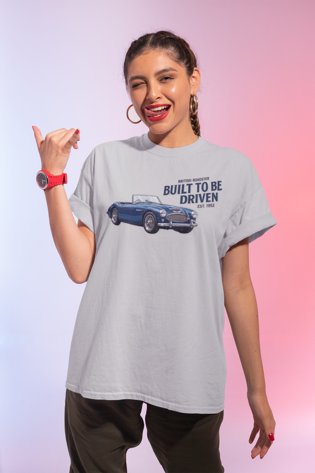 Woman wearing a sport gray t-shirt with a Healey car graphic and text on a gradient background