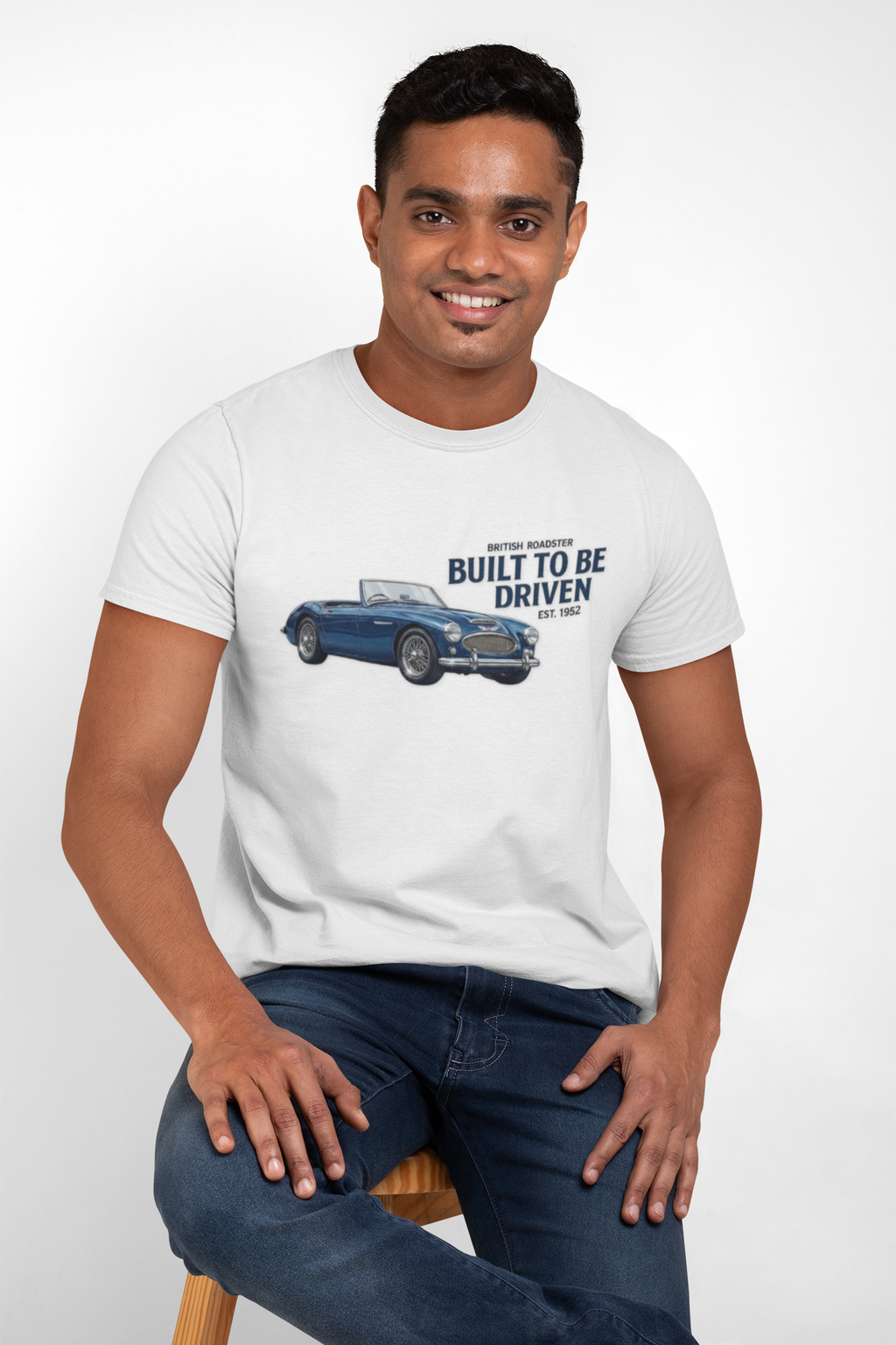 Man wearing a white t-shirt with a Healey car graphic and text on a white background