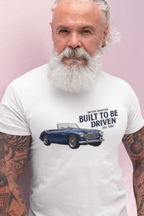Man wearing a white t-shirt with a car design and text on a pink background