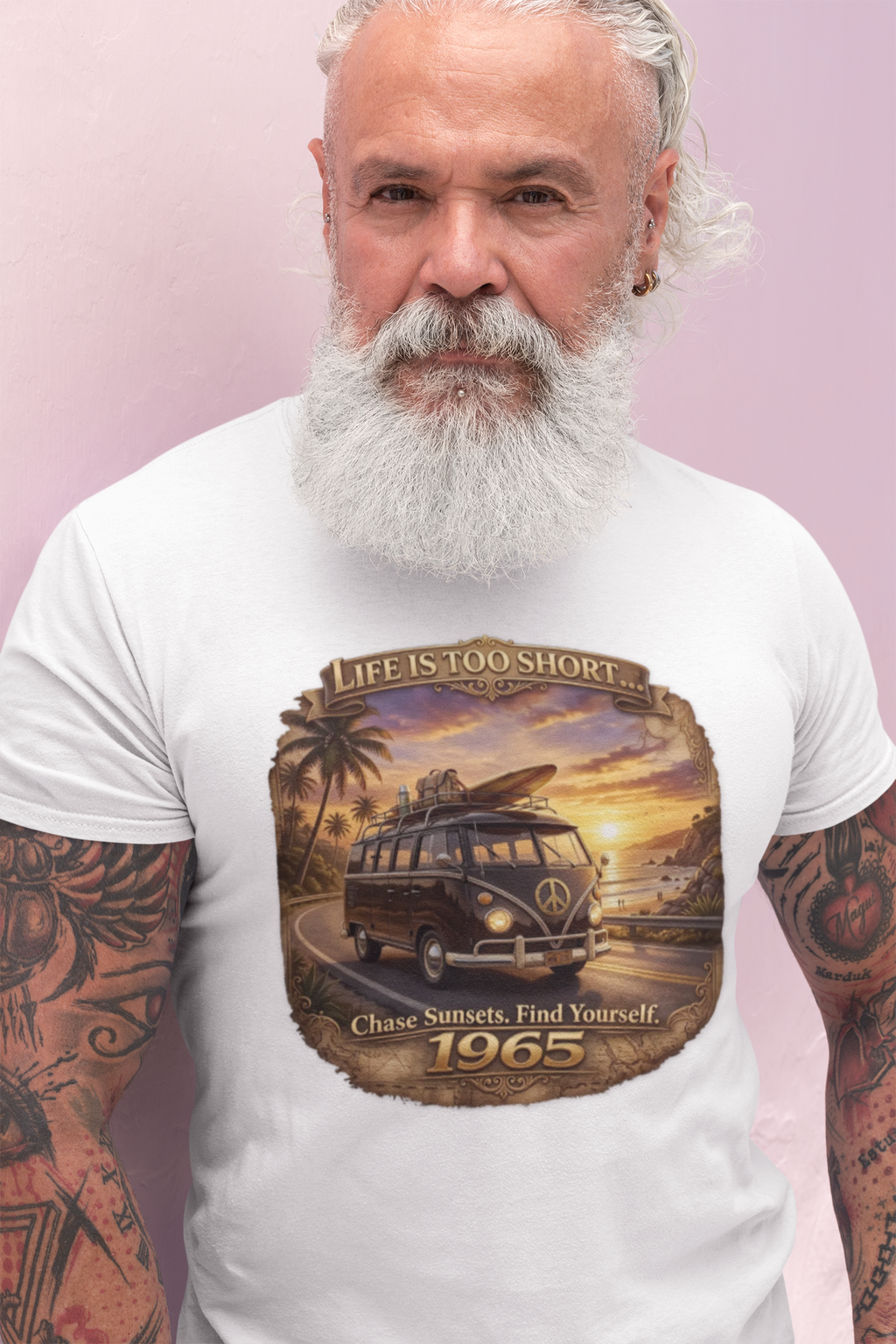 Man wearing a vintage 1965 surfer van white t-shirt with retro beach sunset graphic and “Chase Sunsets. Find Yourself.”