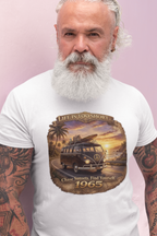 Man wearing a vintage 1965 surfer van white t-shirt with retro beach sunset graphic and “Chase Sunsets. Find Yourself.”