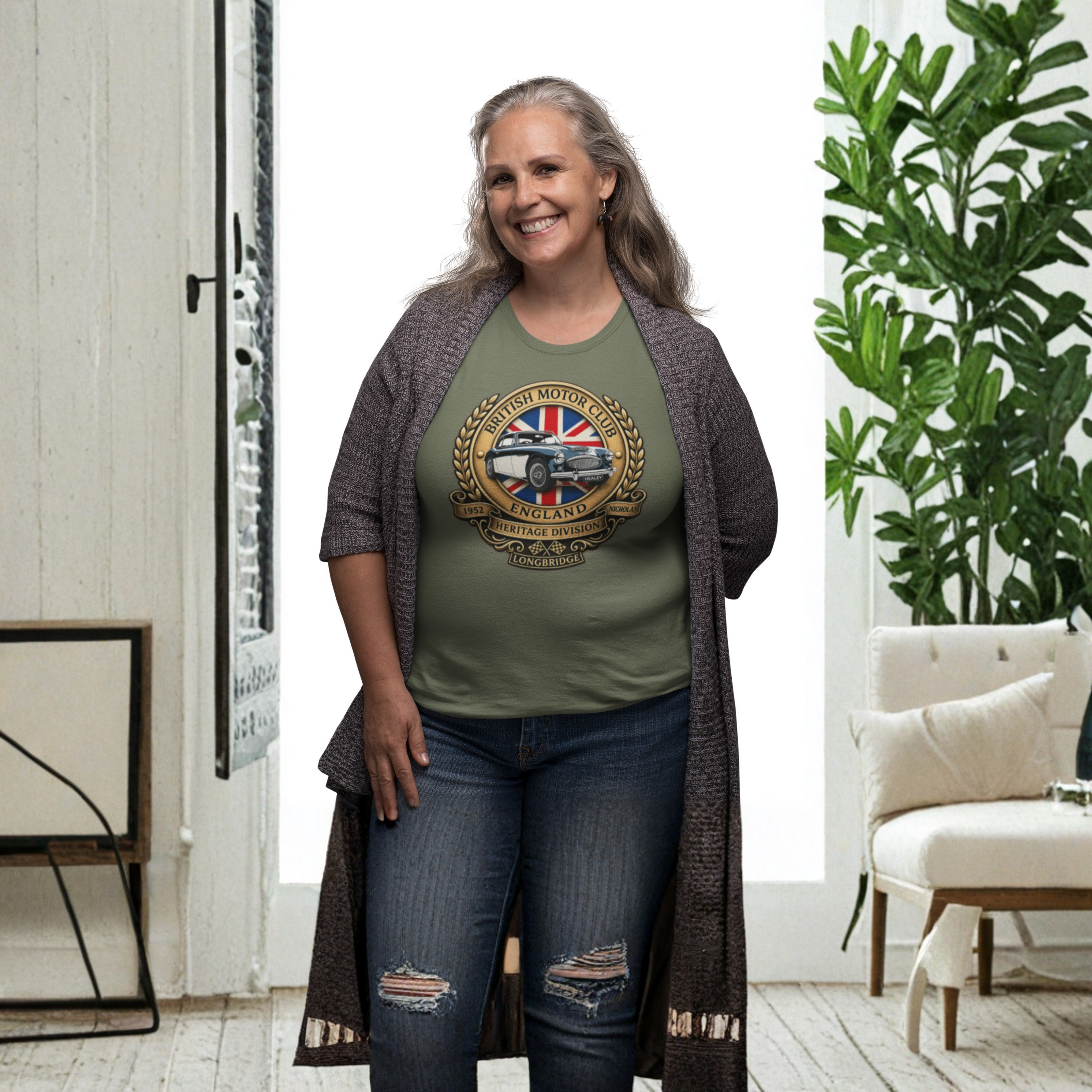 Woman wearing a military green t-shirt with a British Motor Club logo design in a living room setting
