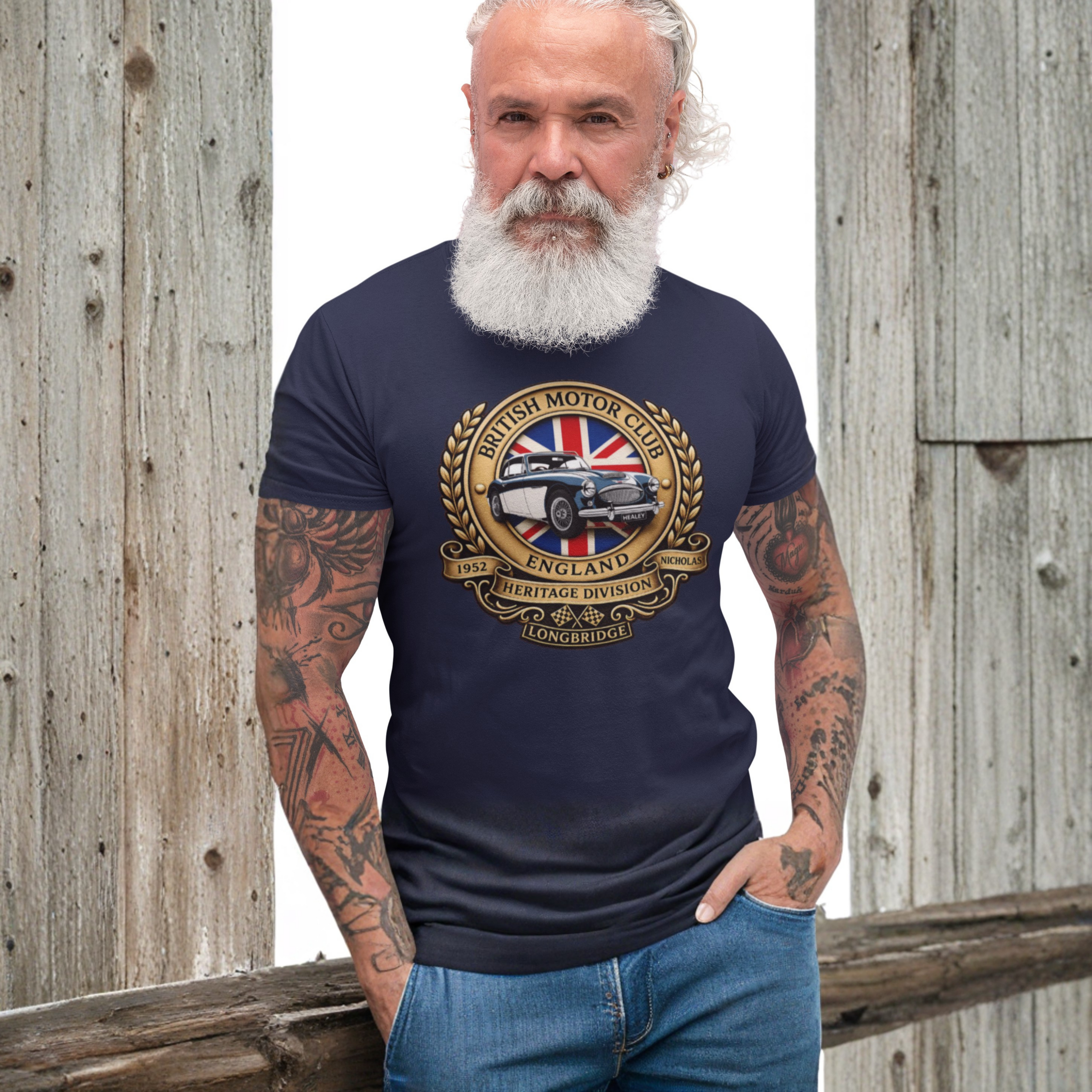 Man wearing a navy blue t-shirt with a British Motor Club logo against a wooden background