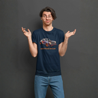 Man wearing a navy blue t-shirt with a graphic design and text, standing against a dark gray background