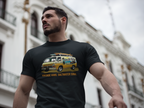 Man wearing a black t-shirt with a vintage van graphic and text, standing in front of a building.