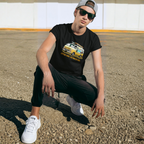 Man wearing a black t-shirt with a graphic classic van design, sunglasses, and a cap in an outdoor setting.