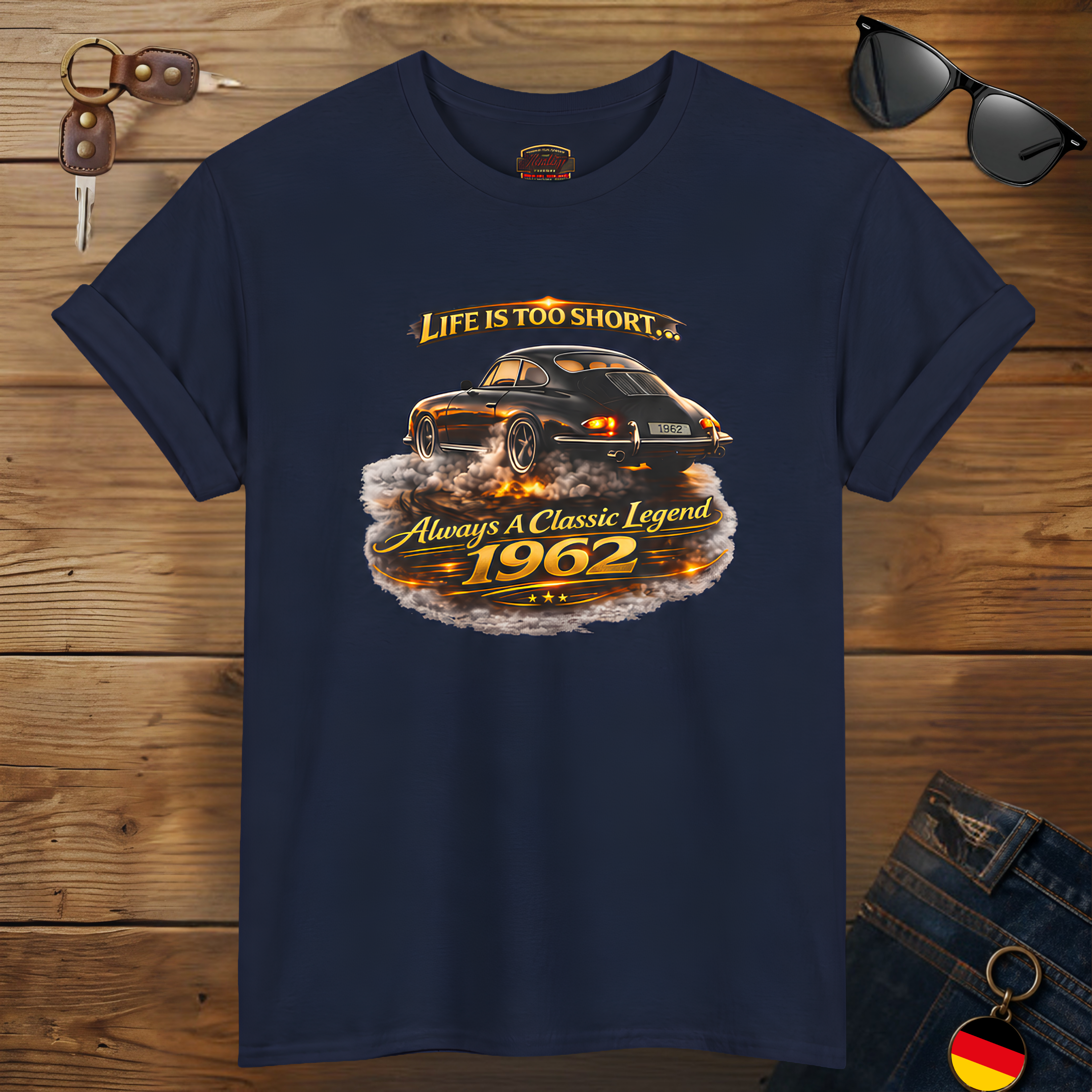 Navy blue t-shirt with vintage car graphic and text on a wooden surface.