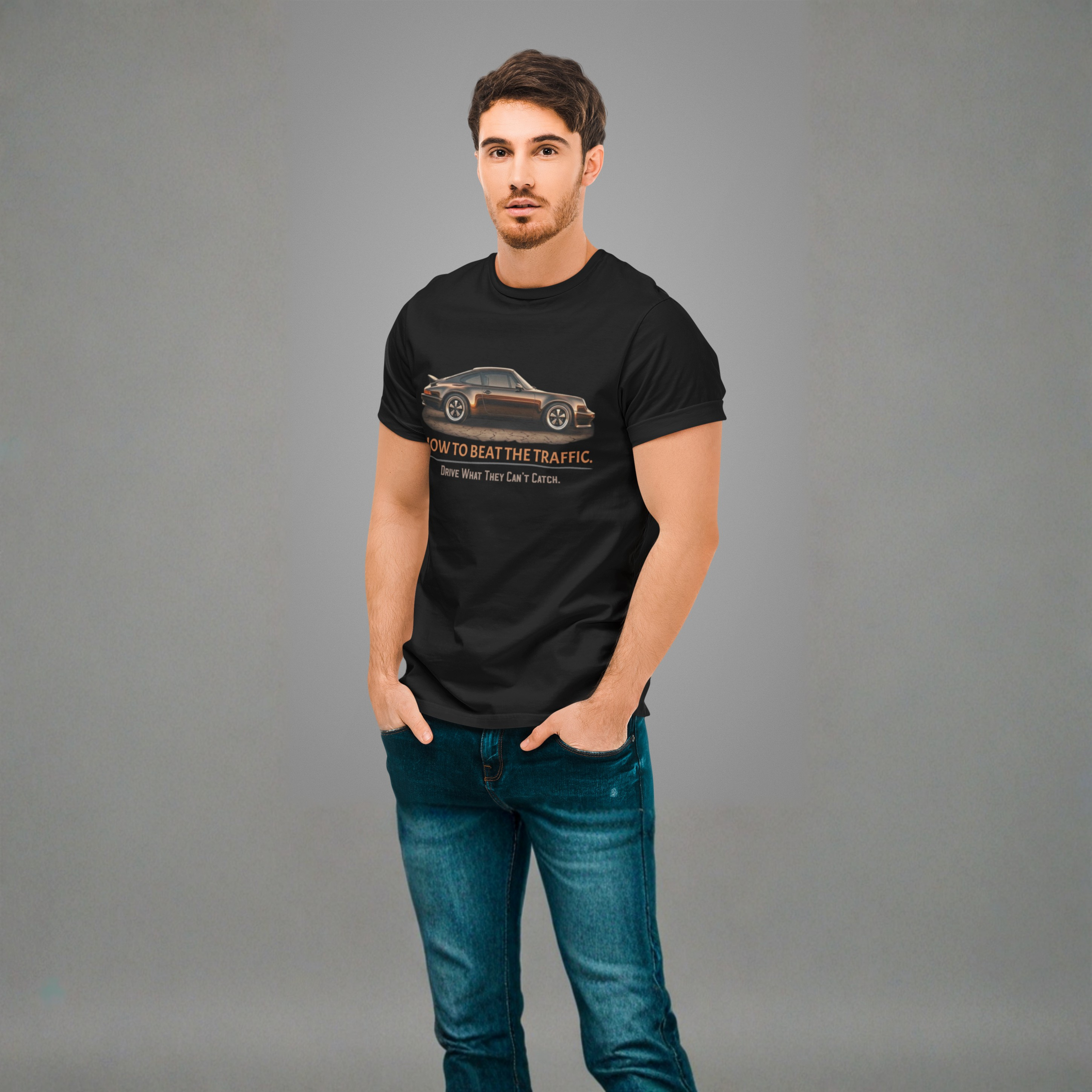 Man wearing a black t-shirt with a classic car graphic design on a gray background