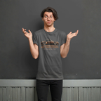 Man wearing a gray t-shirt with a classic car graphic and text, standing against a plain background