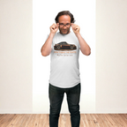 Man wearing a white t-shirt with a classic car graphic design on a plain background