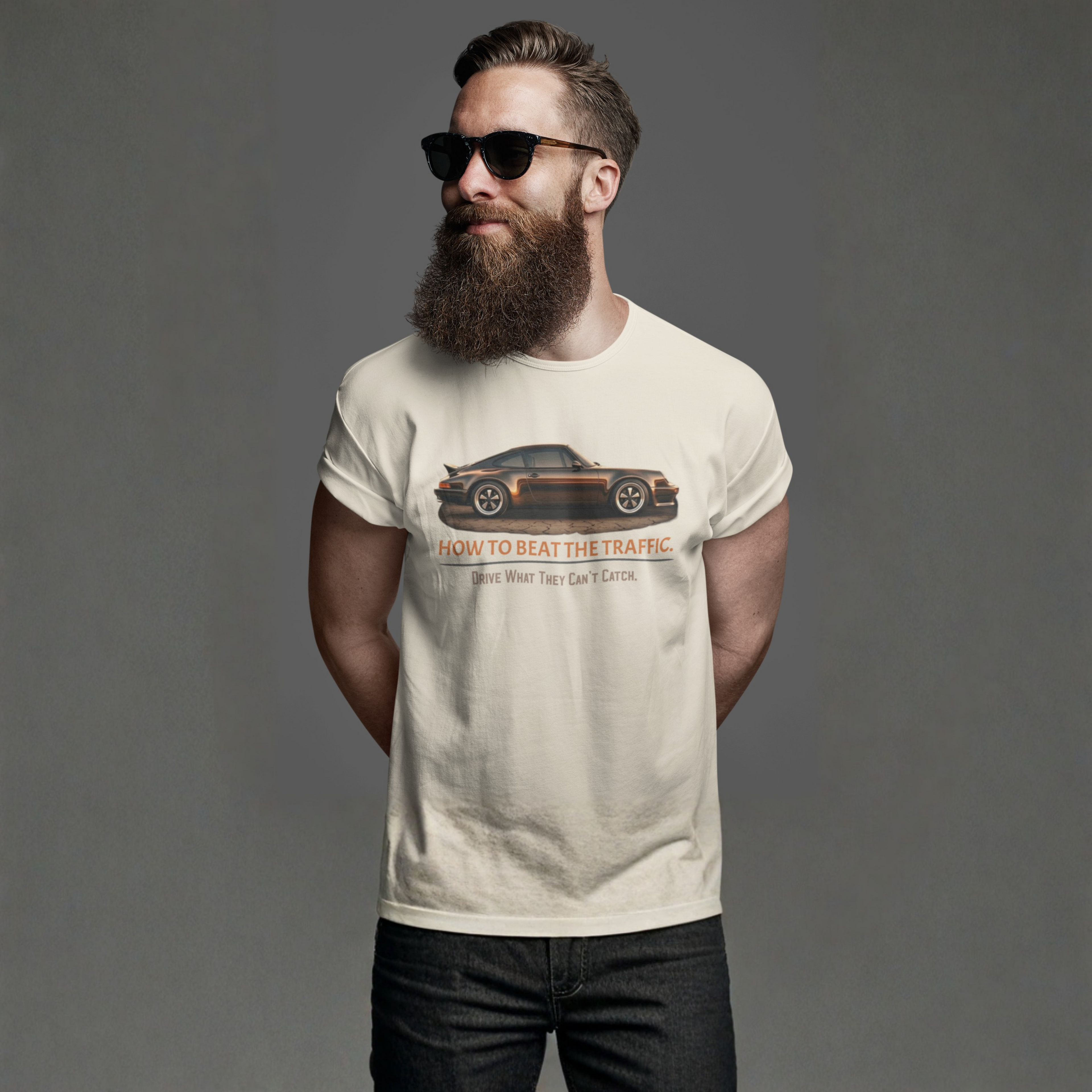 Man wearing a t-shirt with a classic car graphic design on a gray background