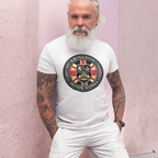 A man with a long white beard and tattooed arms wears a white crewneck t-shirt featuring a circular 'Abingdon Motor Works' crest graphic on the chest, posed against a textured light pink wall.