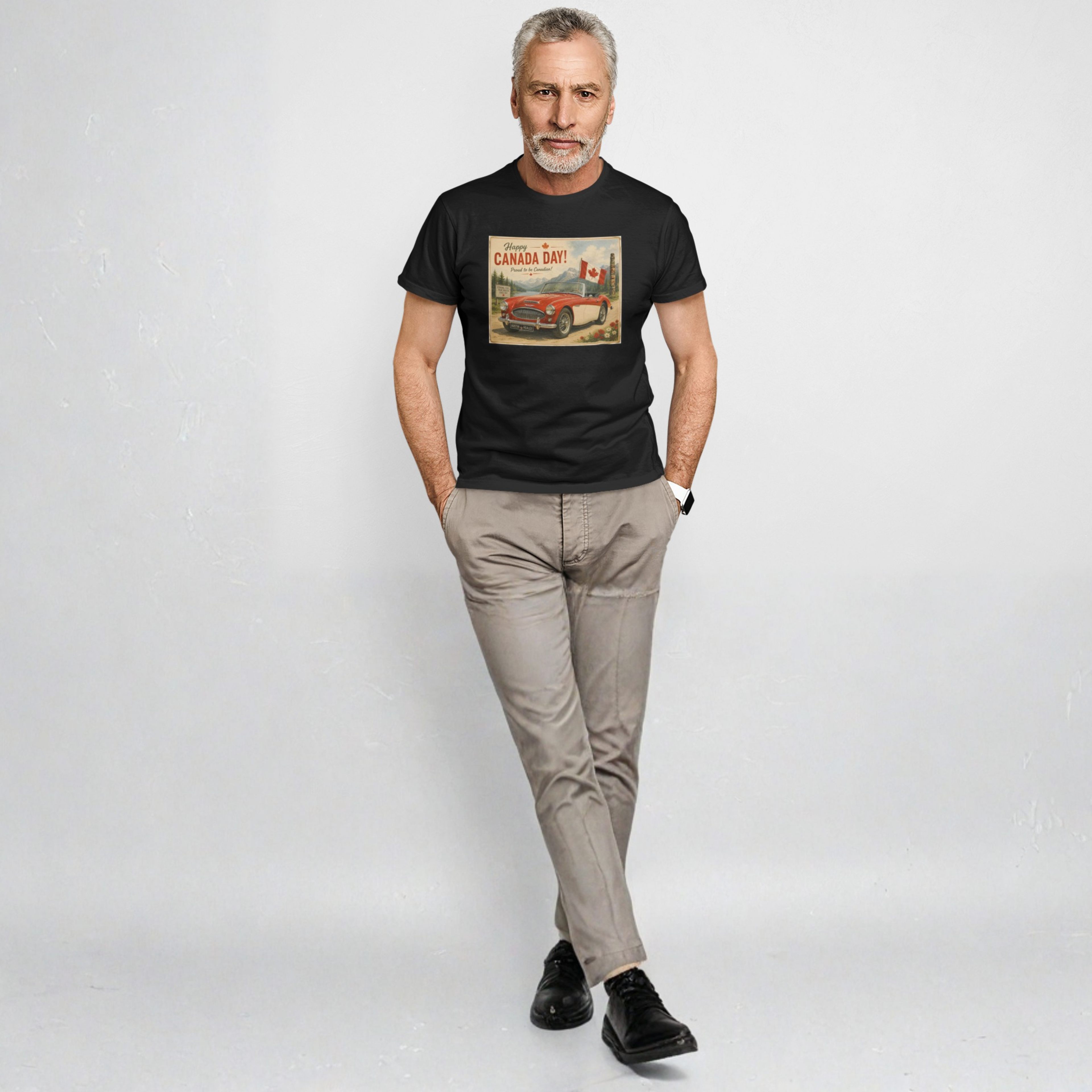A man modeling a black short-sleeve graphic t-shirt with a vintage 'Cruiser Sport' print, paired with beige pants and black shoes, standing against a light gray studio background.