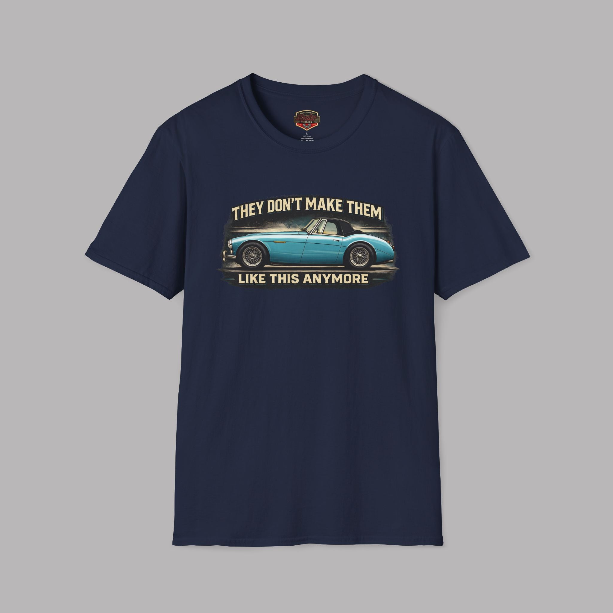 Navy blue t-shirt with vintage car graphic and text on a gray background