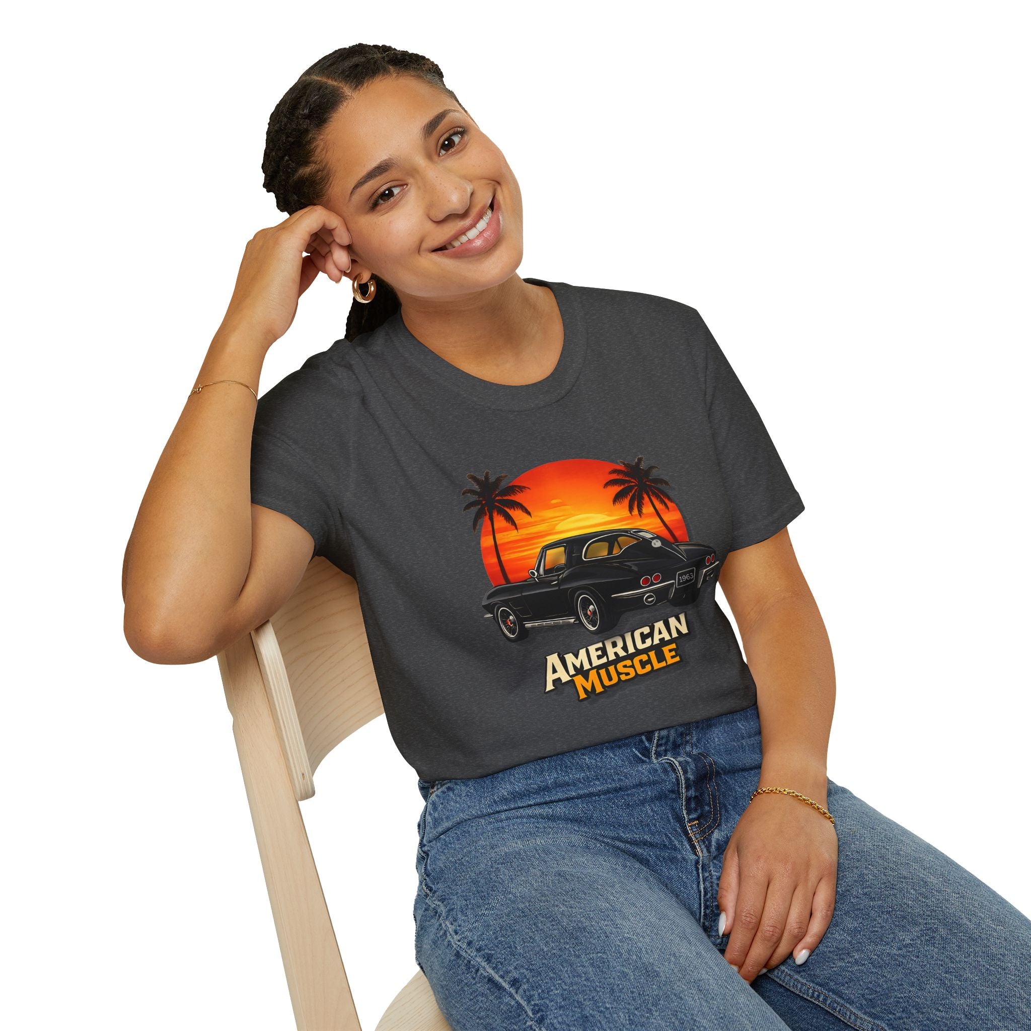 Woman wearing a dark gray t-shirt with 'American Muscle' graphic design, sitting on a white background.