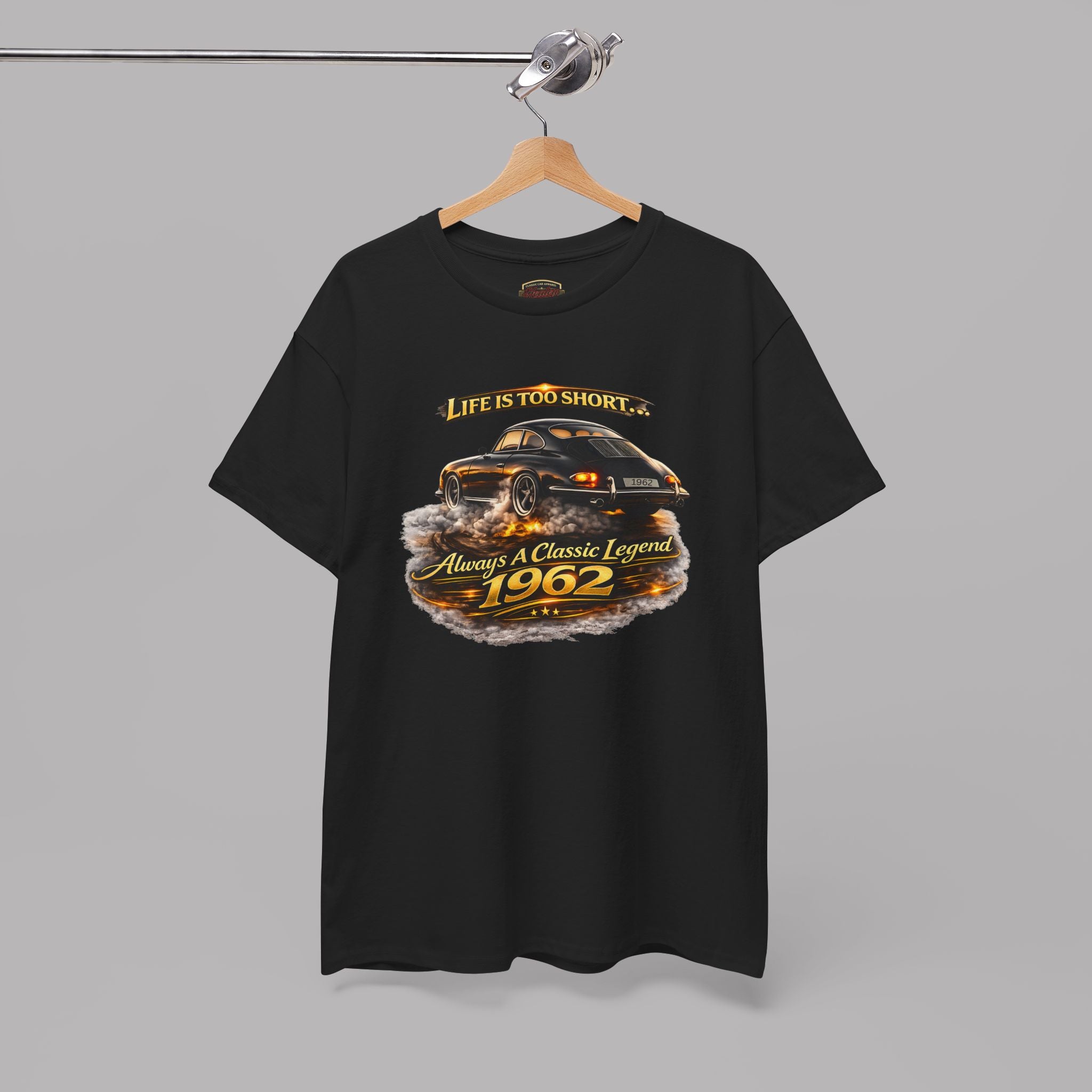 Black t-shirt with a classic car graphic and text on a hanger against a gray background