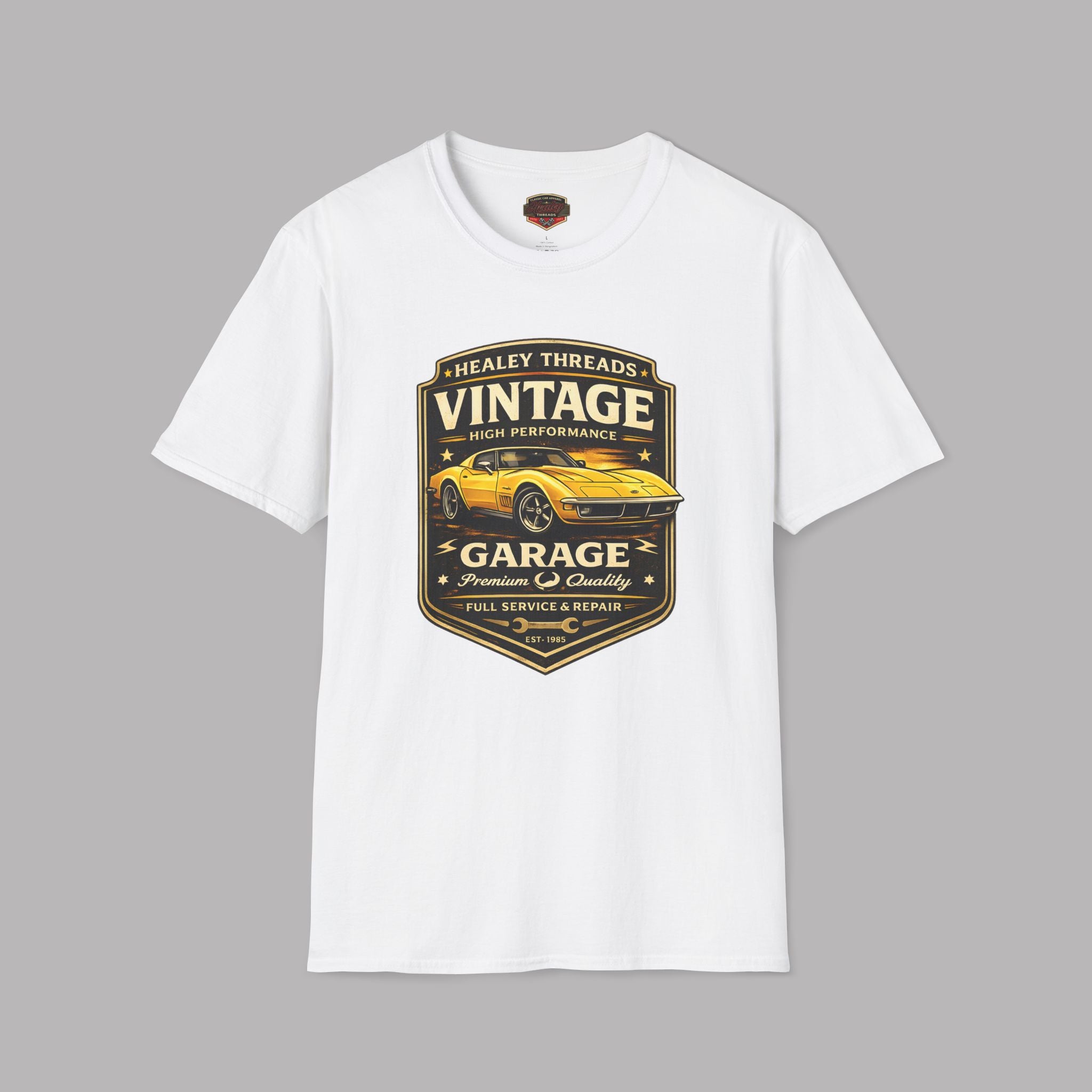White t-shirt with vintage classic car graphic on a gray background