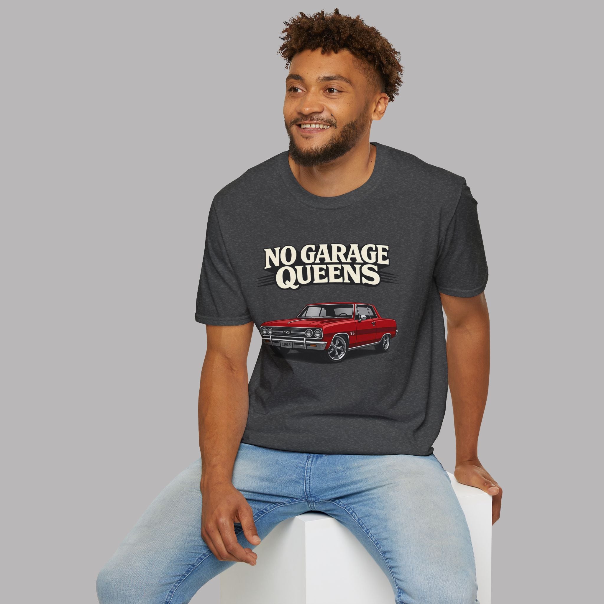 Man wearing a dark heather t-shirt with 'No Garage Queens' and a car graphic on a gray background