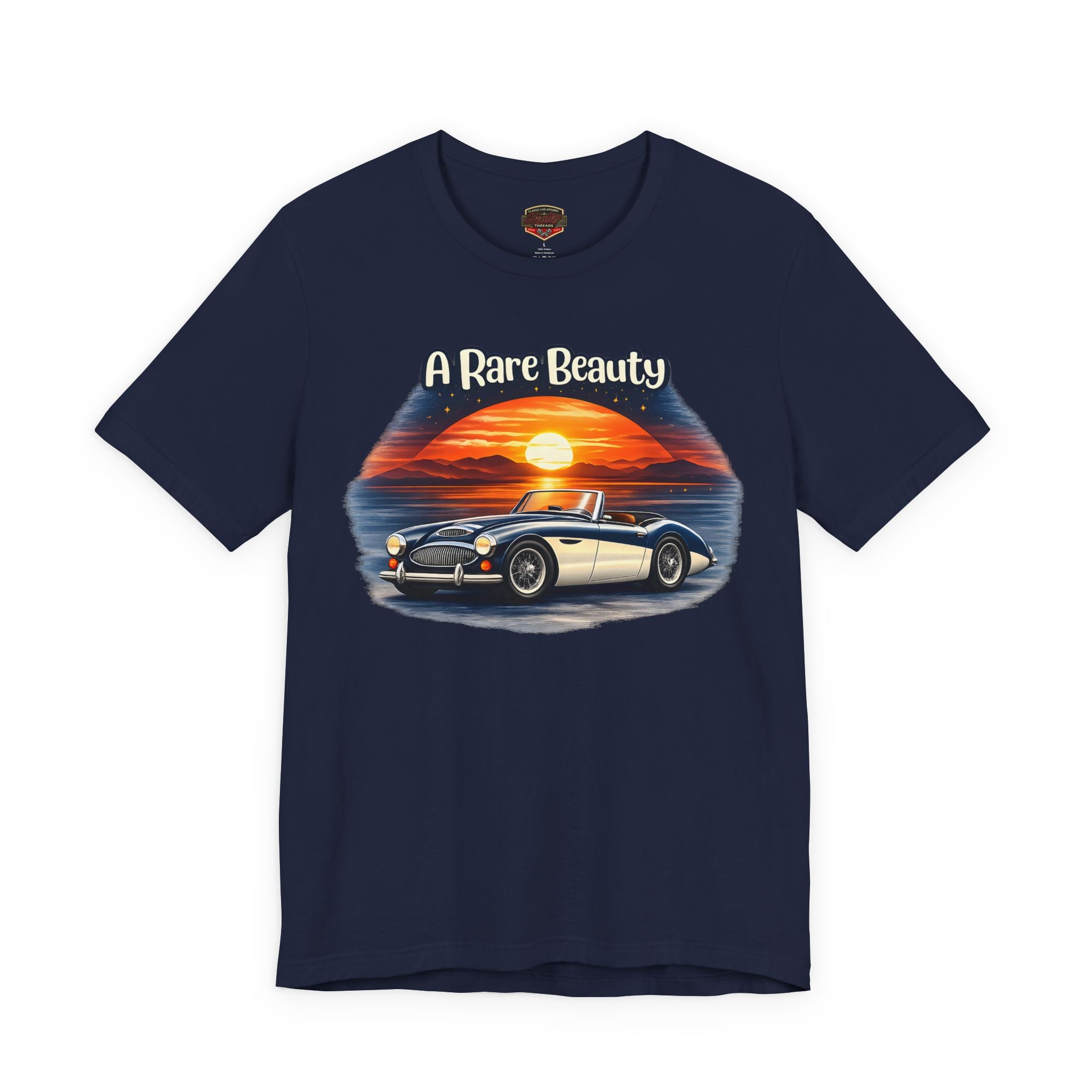 Navy blue t-shirt with a Healey graphic of a classic car and sunset, text 'A Rare Beauty' on a white background.