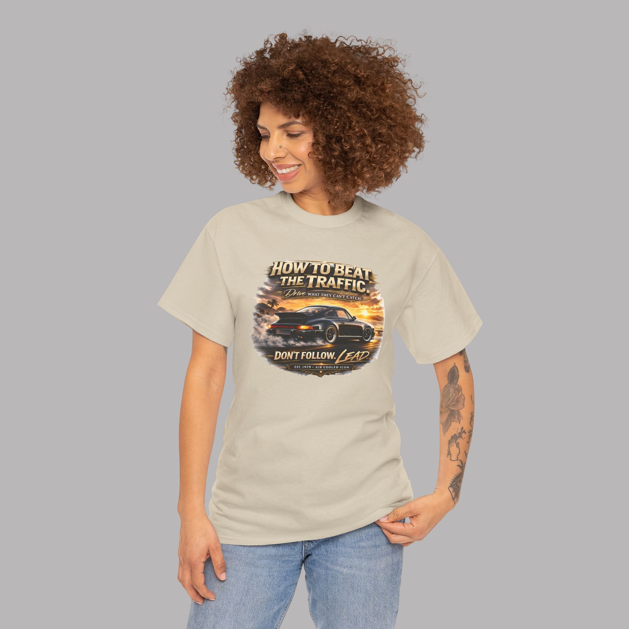 Woman wearing a sand t-shirt with a classic car graphic design and text on a gray background