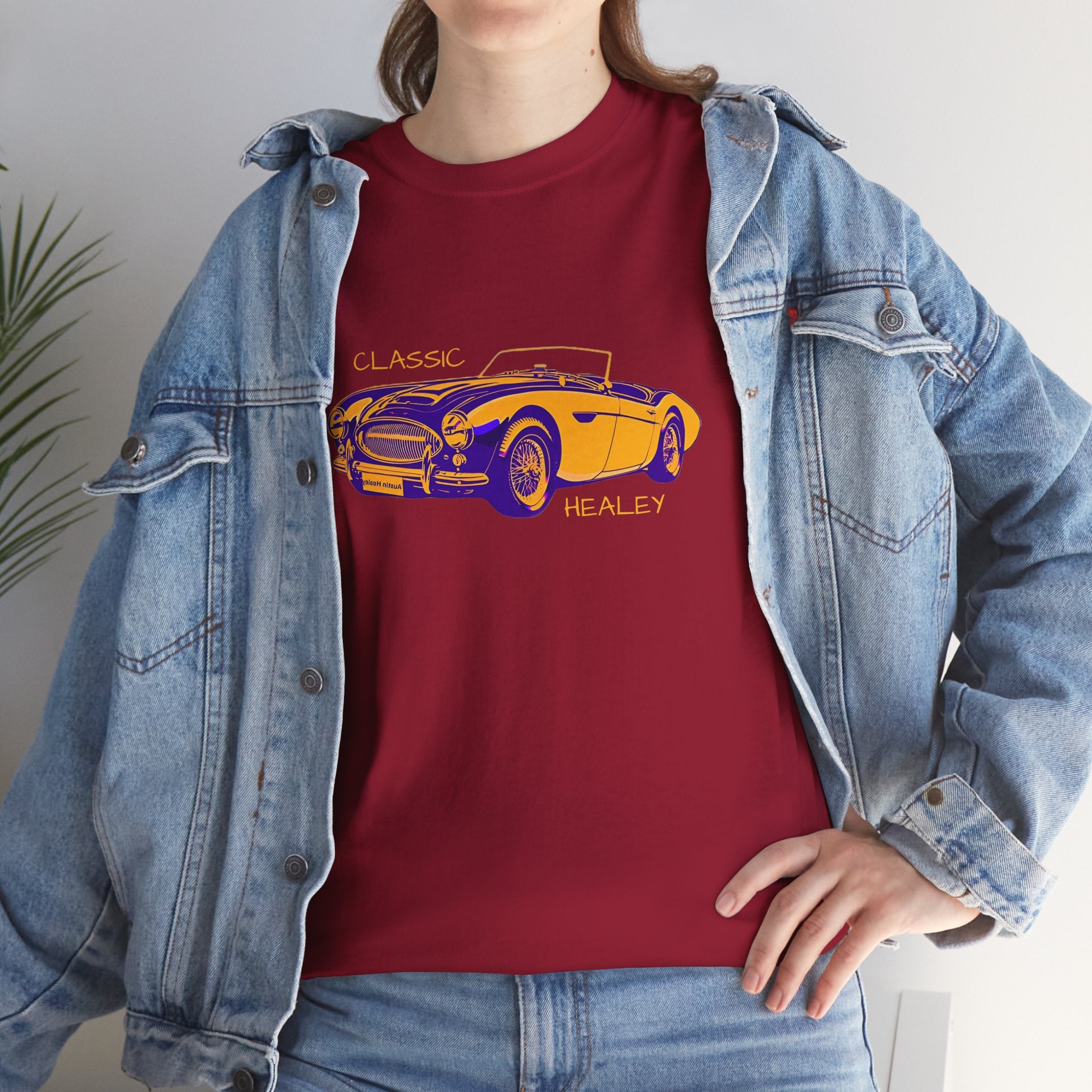 Girl wearing a red t-shirt with a yellow and blue classic car graphic, paired with a denim jacket.