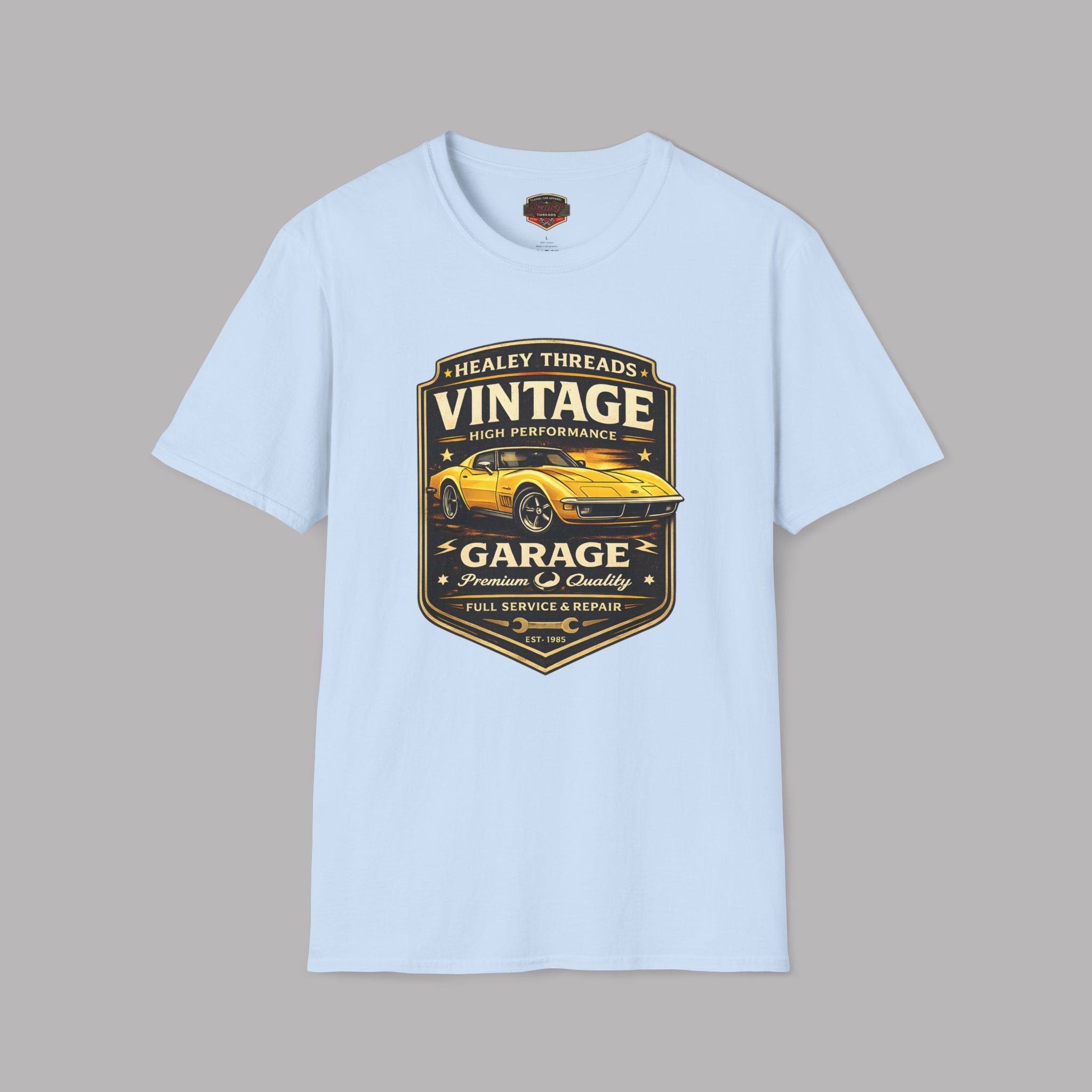 Light blue t-shirt with vintage classic car  graphic on a gray background