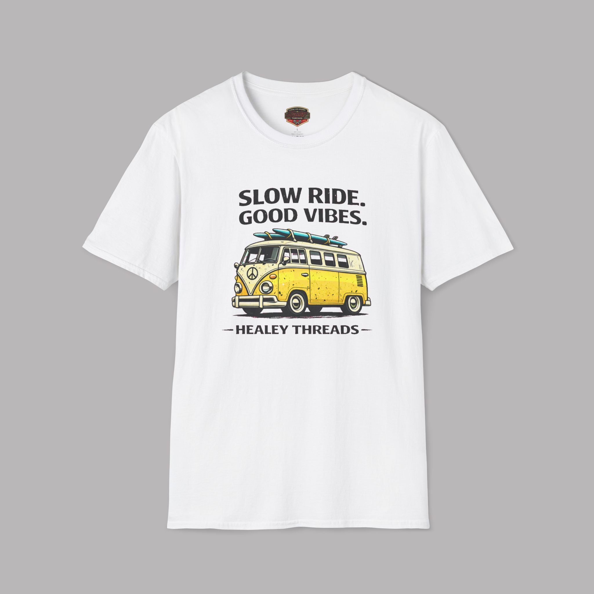 White t-shirt with a yellow van graphic and text on a gray background