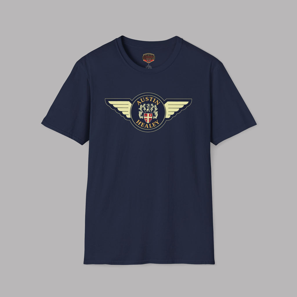 Austin Healey winged badge logo with navy and gold circular emblem, heraldic shield, and cream wings on a navy blue t-shirt flat on gray background