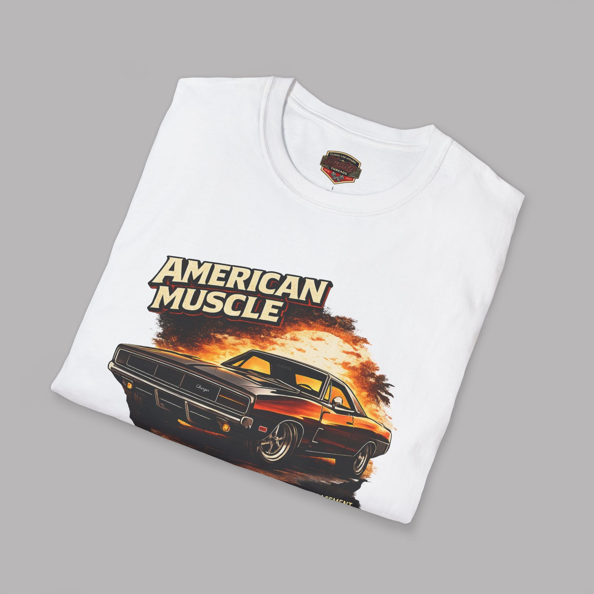 Folded white t-shirt with 'American Muscle' graphic design on a gray background