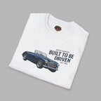 Folded white t-shirt with a blue vintage car graphic and text on a gray background