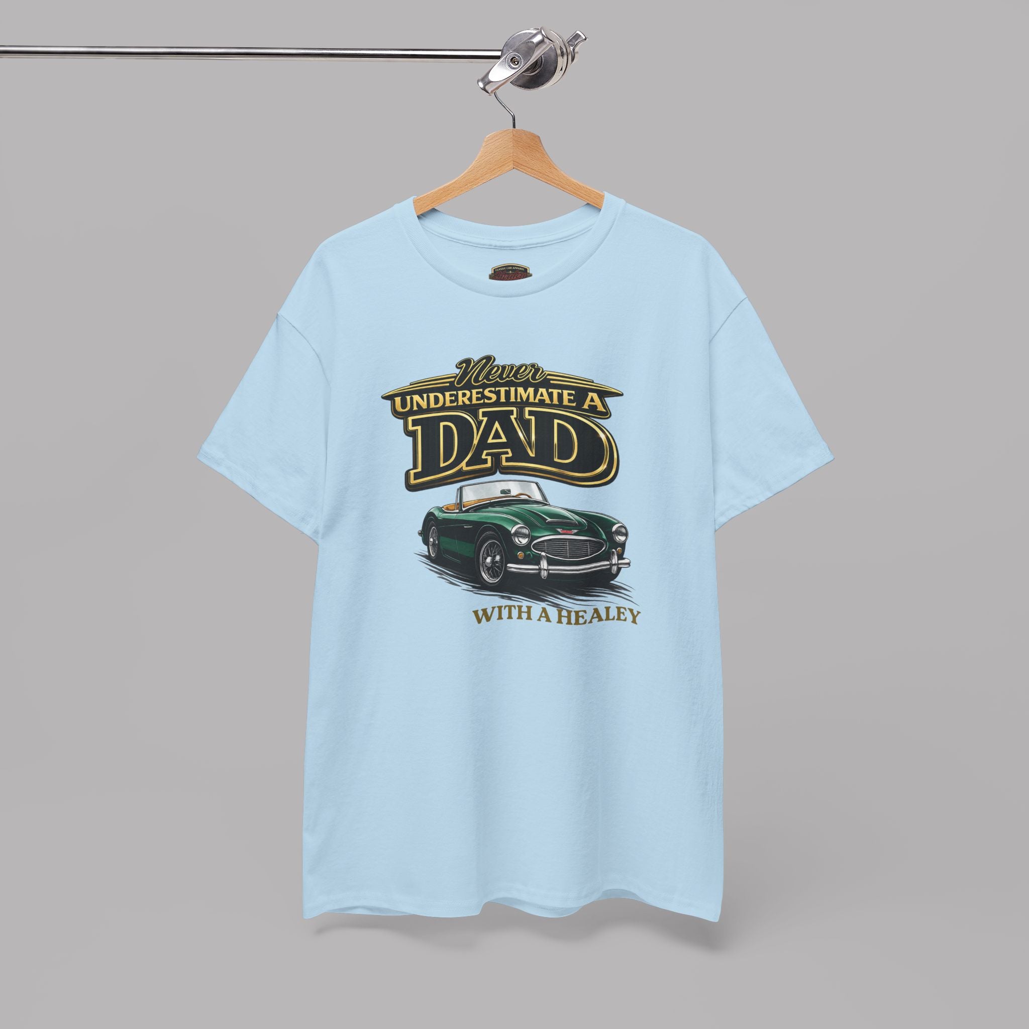 Light blue t-shirt with a graphic design of a car and text on a hanger against a gray background
