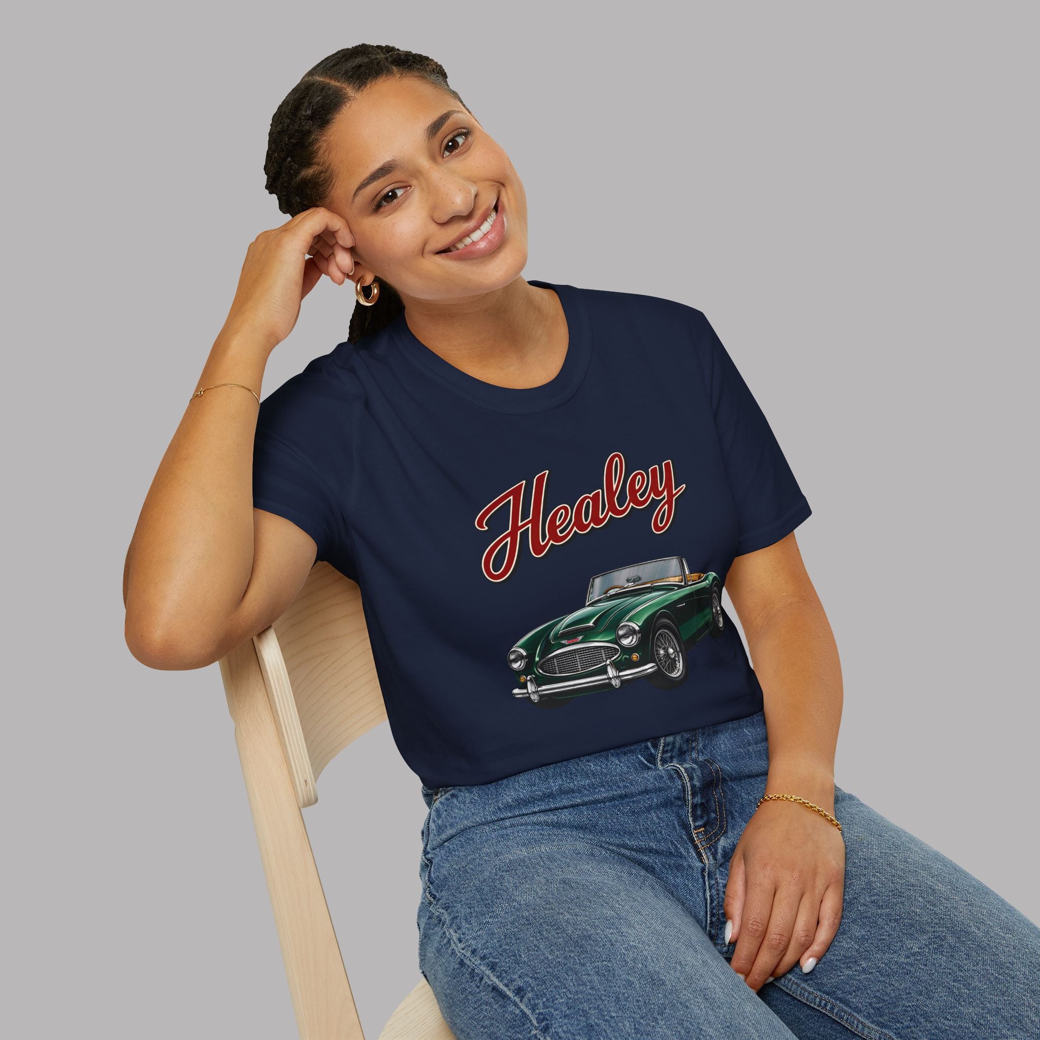 Woman wearing a navy blue t-shirt with 'Healey' and a classic car graphic on a gray background