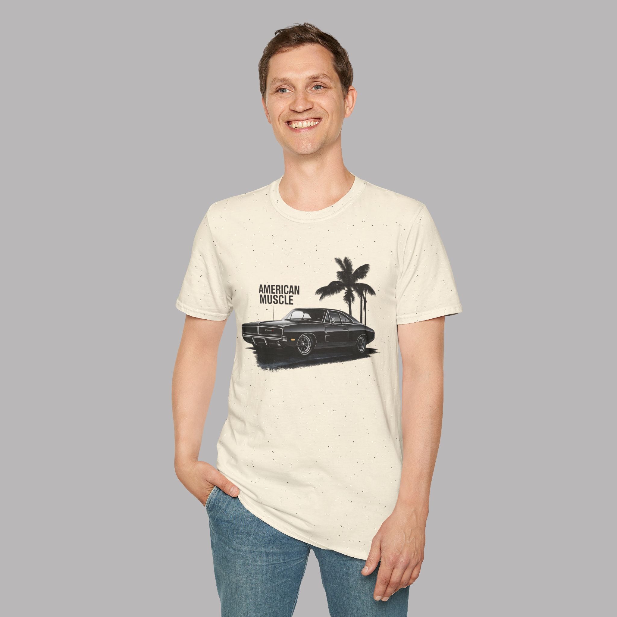 Man wearing a white t-shirt with a graphic design of a car and palm trees on a plain background