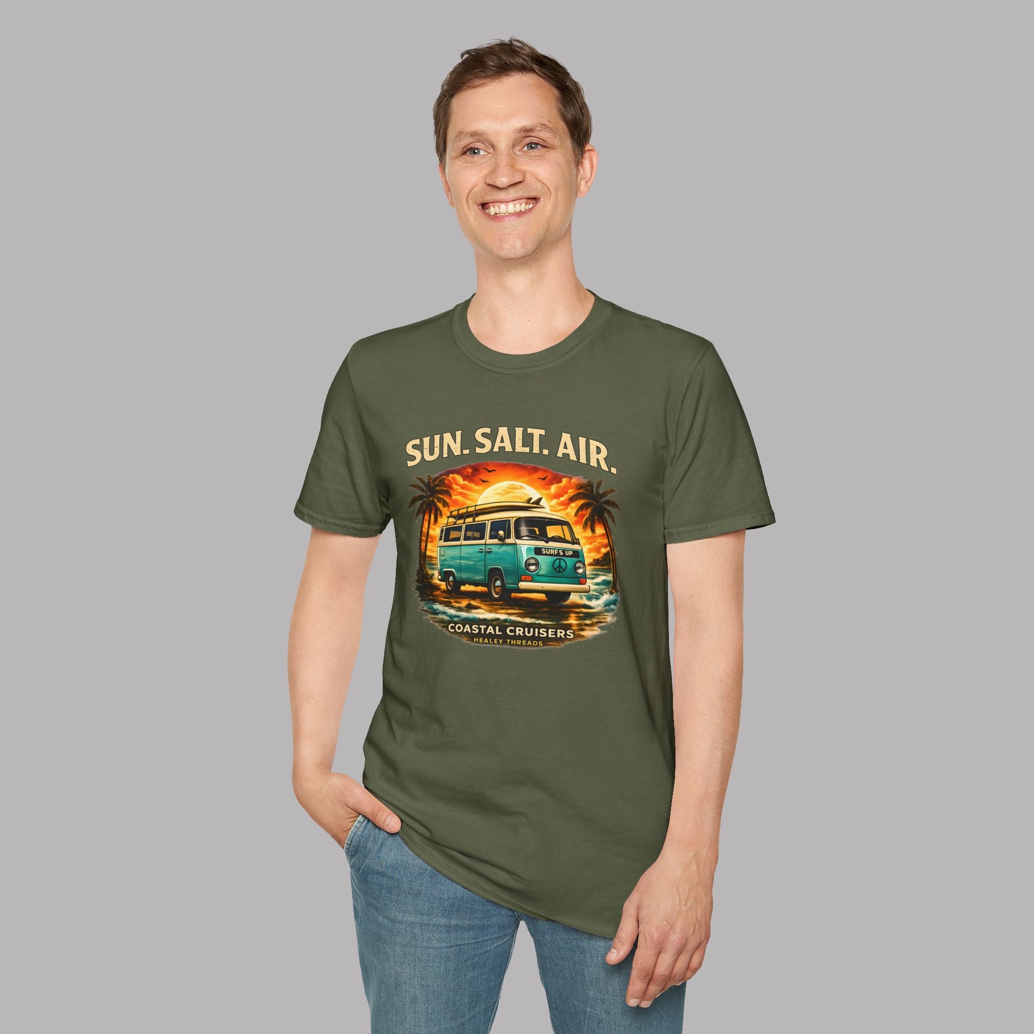 A man wearing an military  green t-shirt with a retro  graphic of a teal bus and the text 'SUN. SALT.