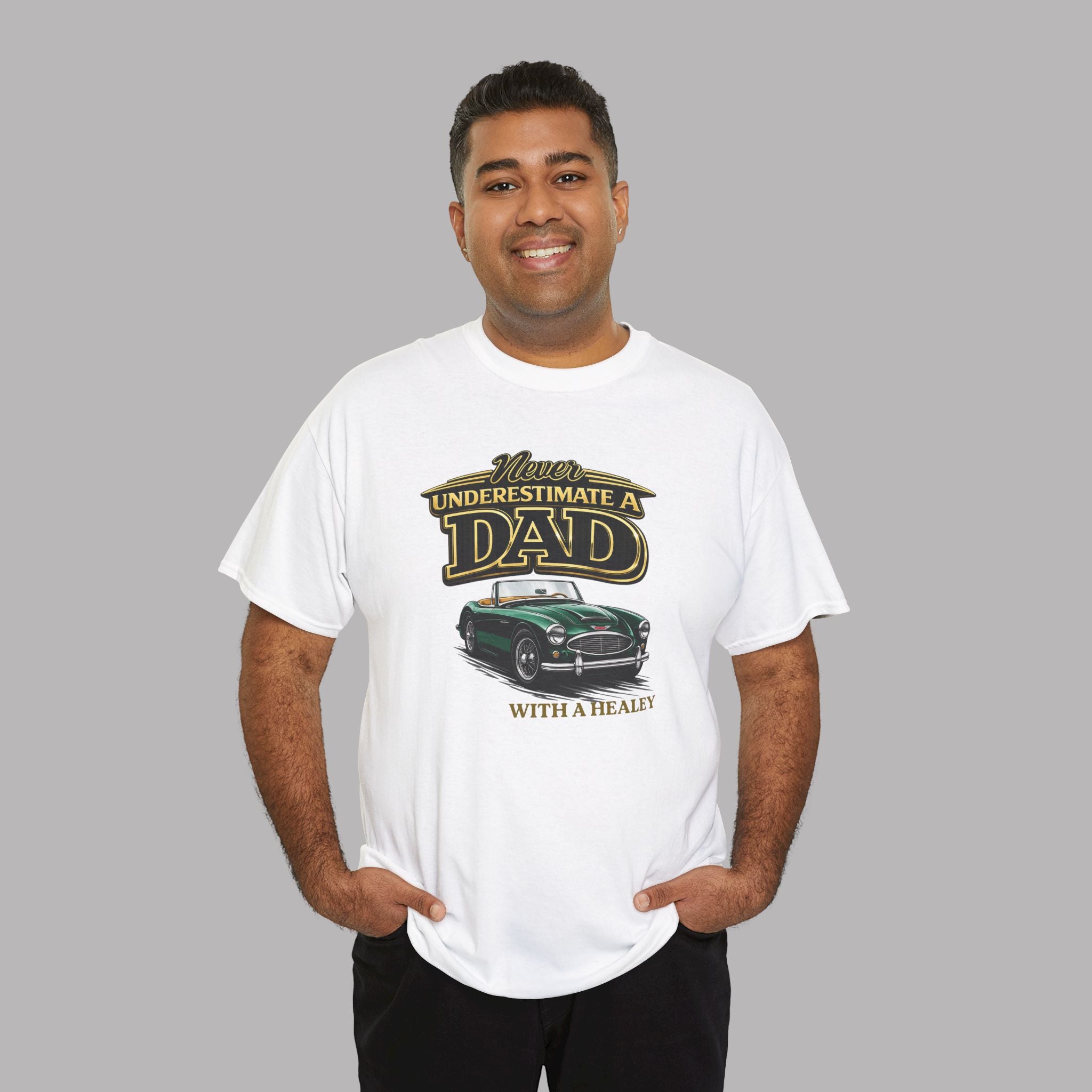 Man wearing a white t-shirt with a classic car graphic design and text on a gray background