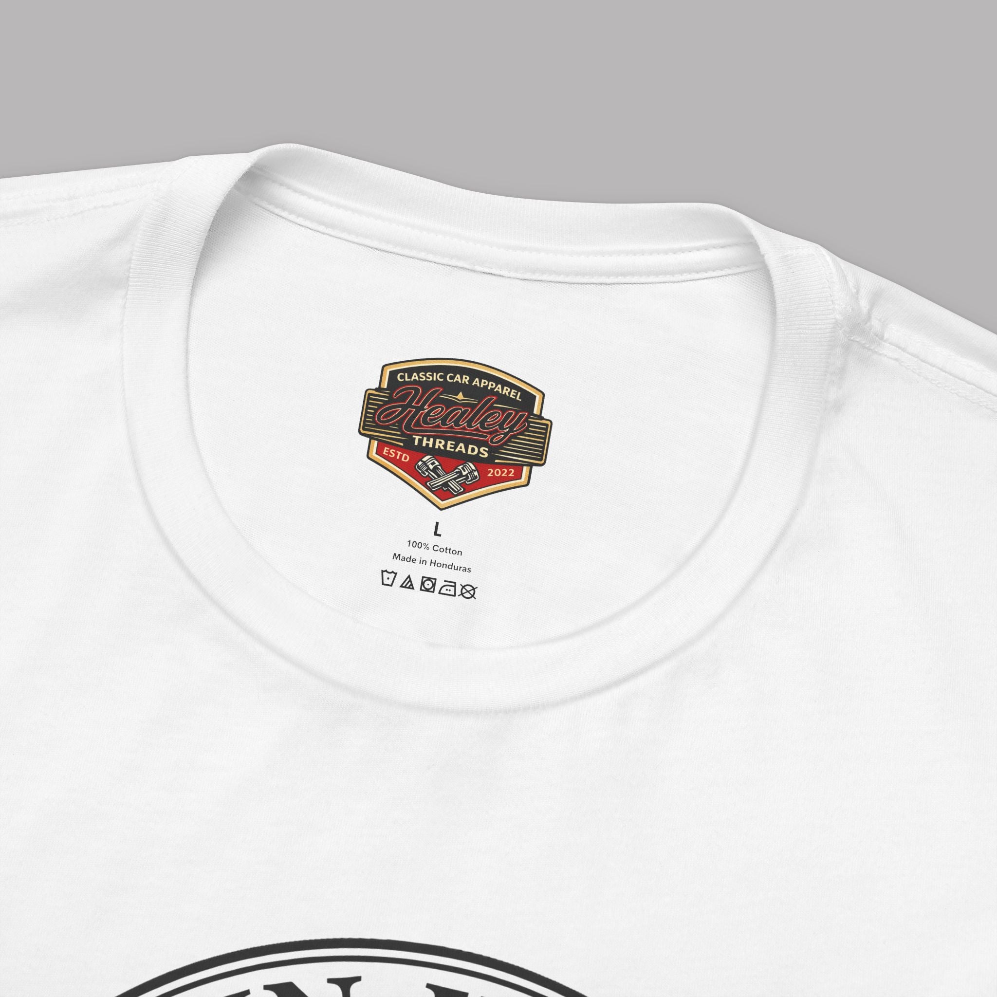 White t-shirt with a Healey Threads logo and text on a gray background