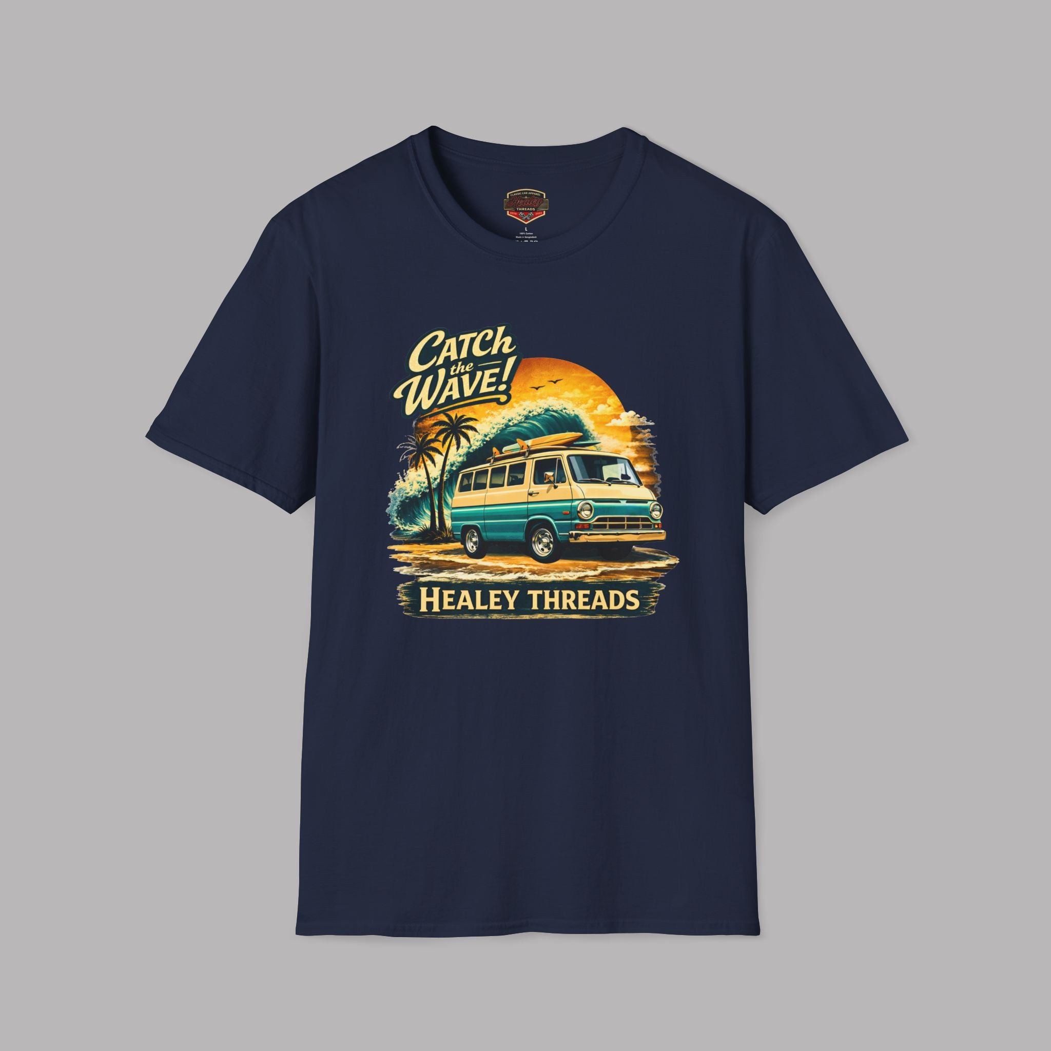 Navy blue t-shirt with a graphic design of a van and text 'Catch Wave! Healey Threads' on a gray background