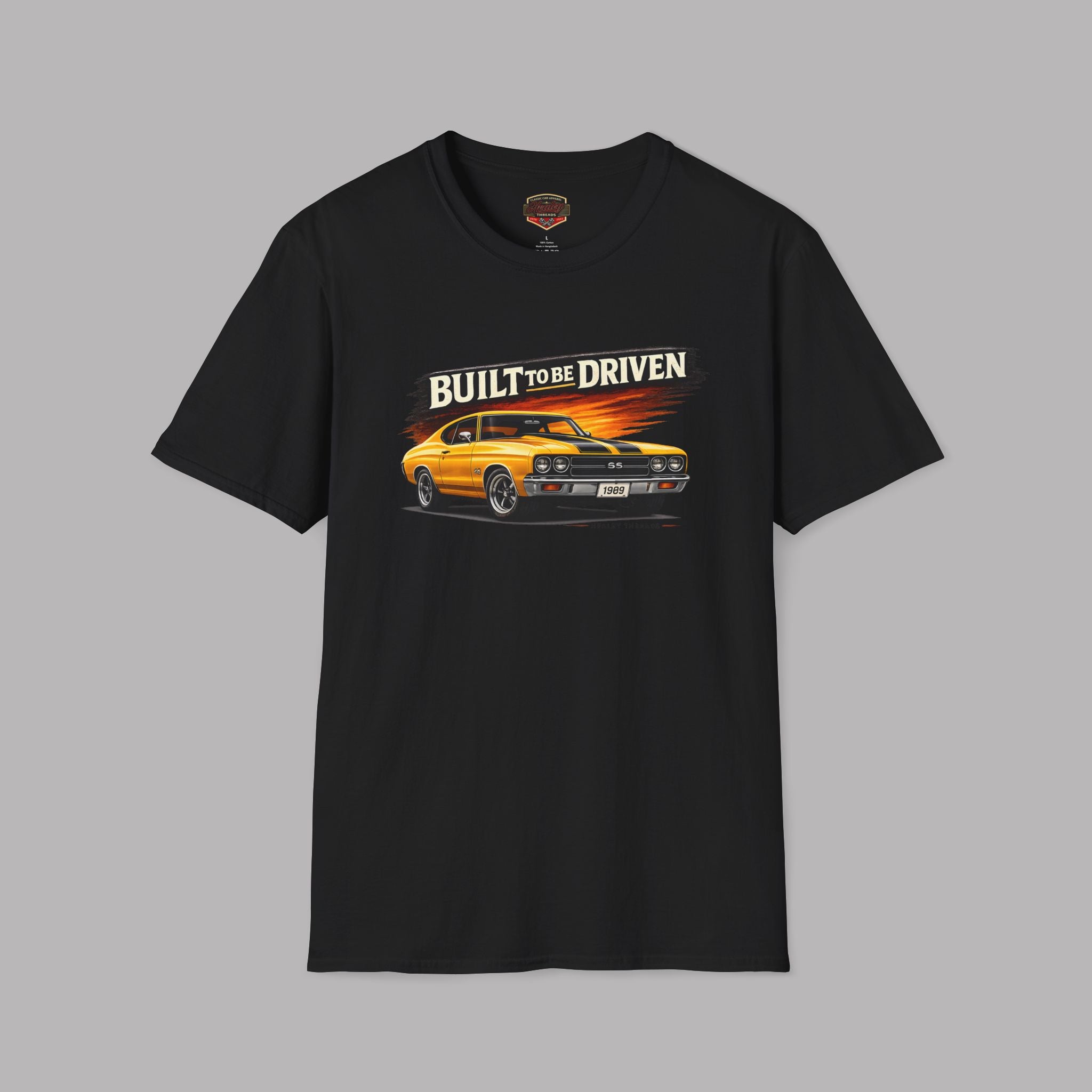 Black t-shirt with a graphic of a car and 'Built to be Driven' text on a gray background