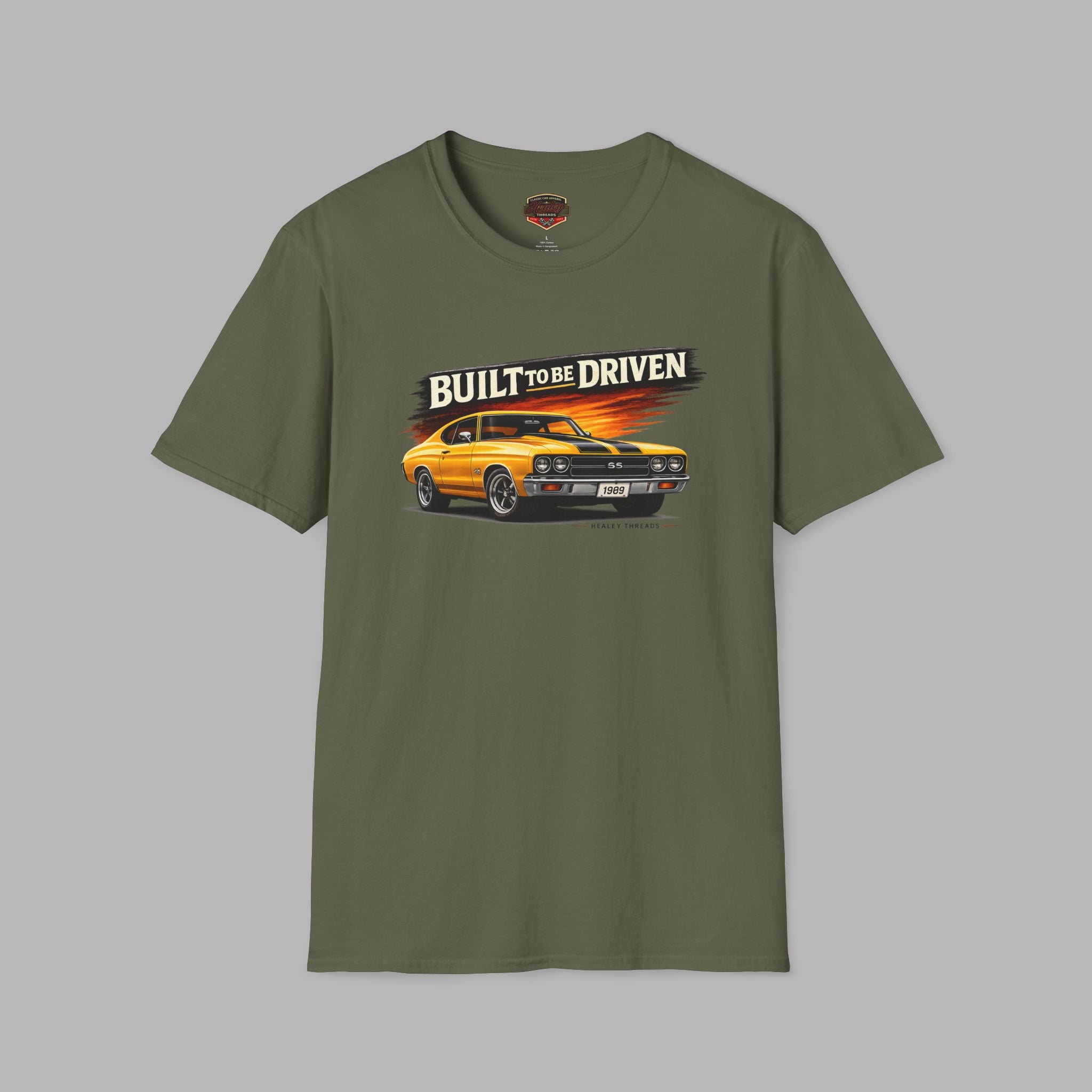 Military green t-shirt with a graphic of a car and 'Built to be Driven' text on a gray background