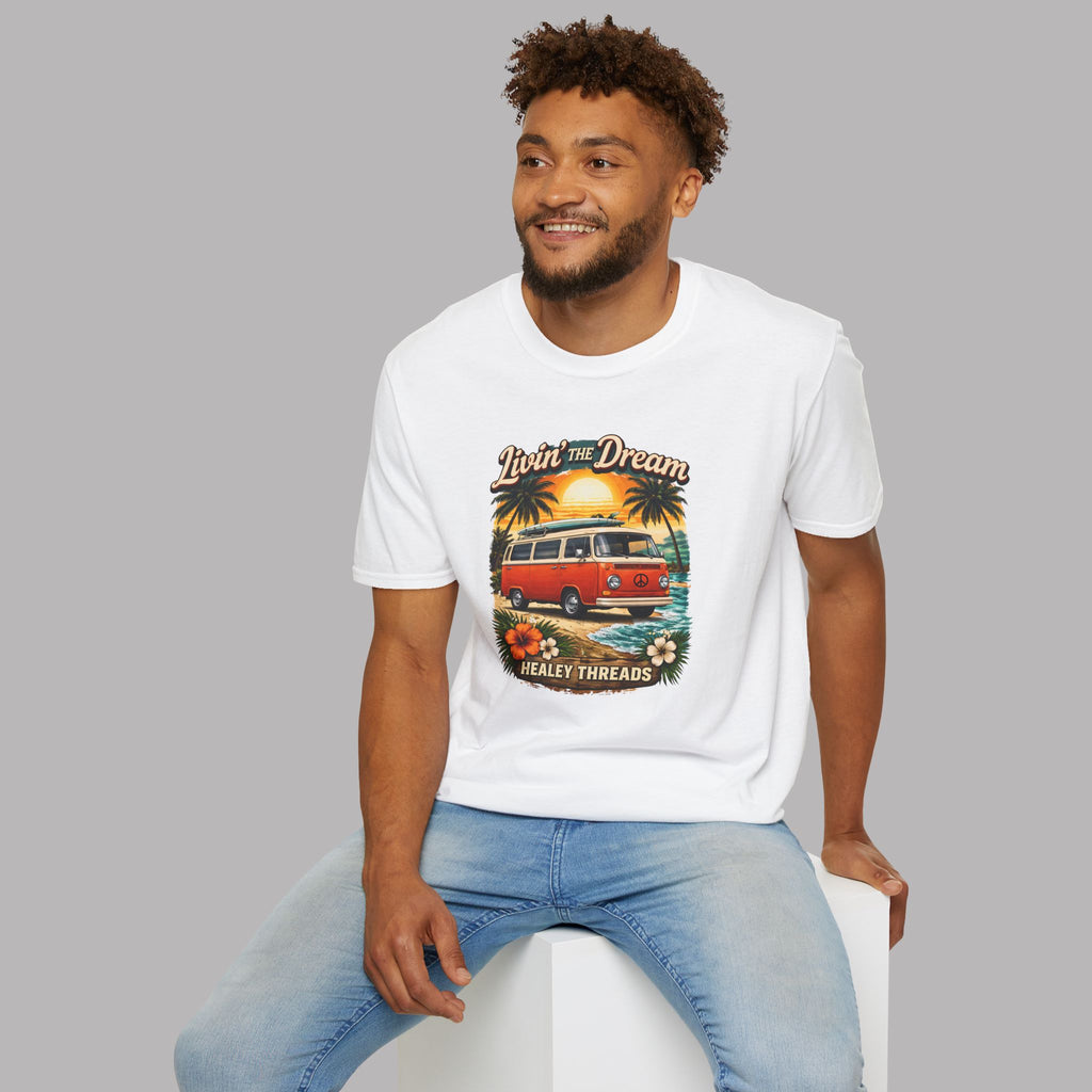 Man wearing a white t-shirt with a graphic van design sitting on a white stool against a gray background