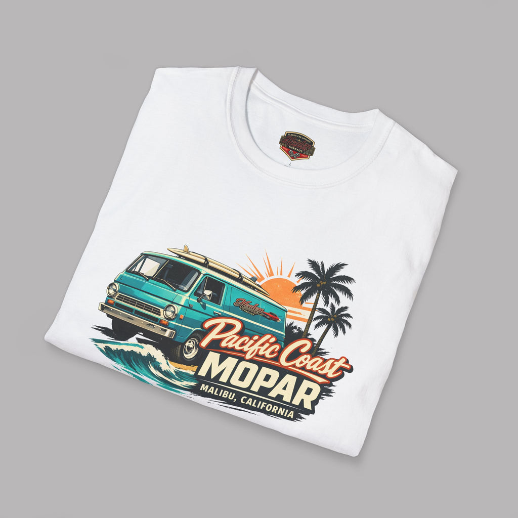 Folded white t-shirt with a colorful graphic van design on a gray background