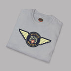 Folded gray t-shirt with Austin Healey logo on a gray background