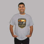 Man wearing a gray t-shirt with a graphic car design on a plain background