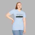 Woman wearing a light blue t-shirt with a classic car graphic and text on a gray background